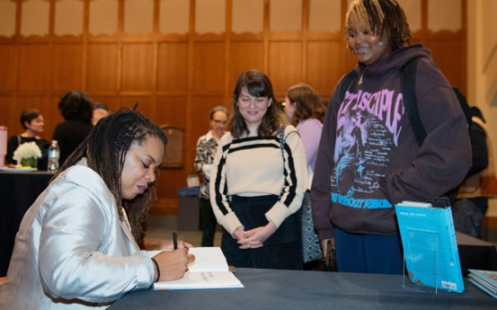 airea matthews signing copies of her poetry collection bread and circus